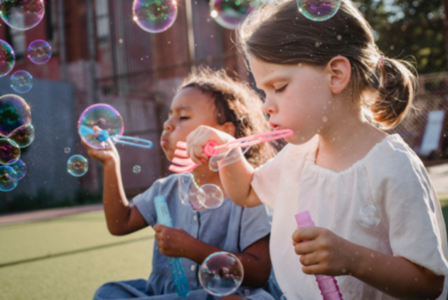 Two children enjoying a playful bubble activity
