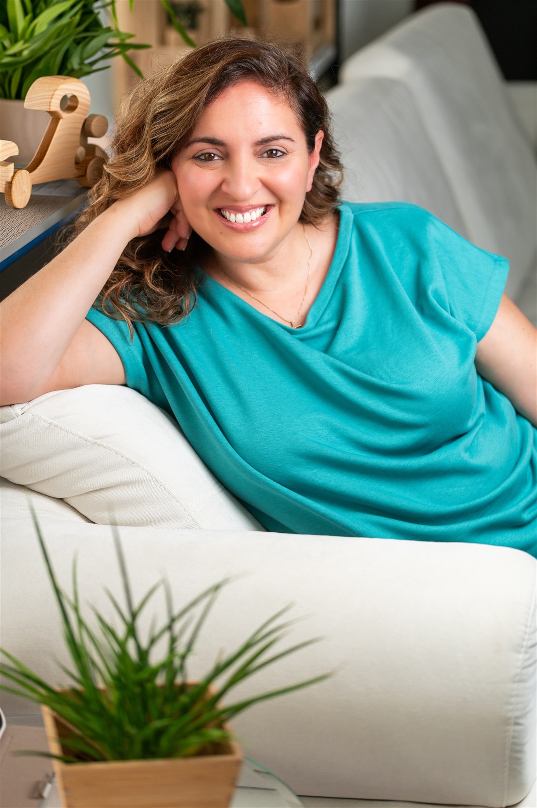 Maria Rakintzaki smiling in her therapy space